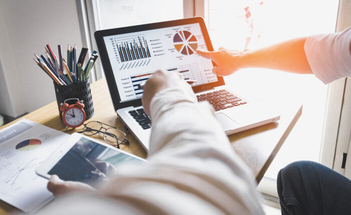 Business person analyzing financial statistics displayed on the