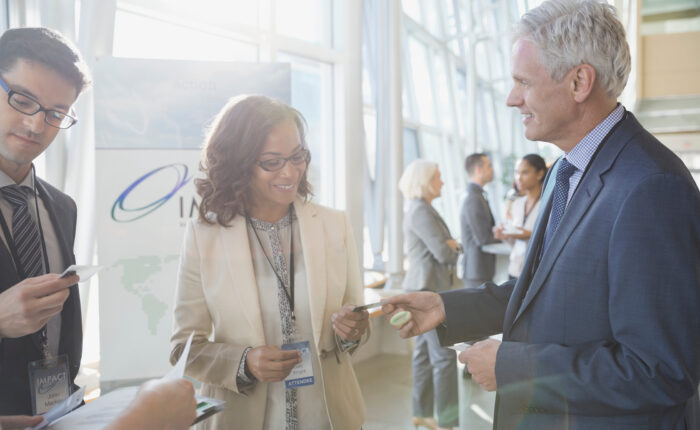 Business professionals exchanging business cards