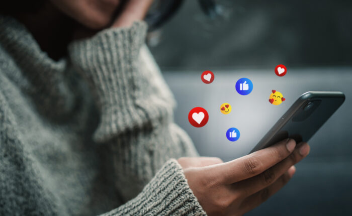 Happy woman looking on smartphone watching social and online ent
