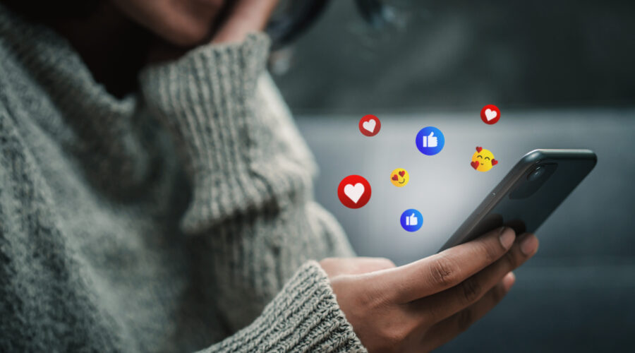 Happy woman looking on smartphone watching social and online ent