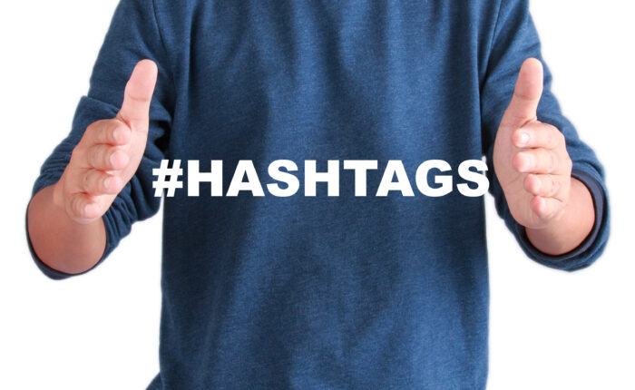 The hands of men with text hashtags