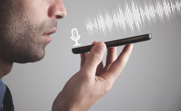 Man talking smartphone using the voice recognition.