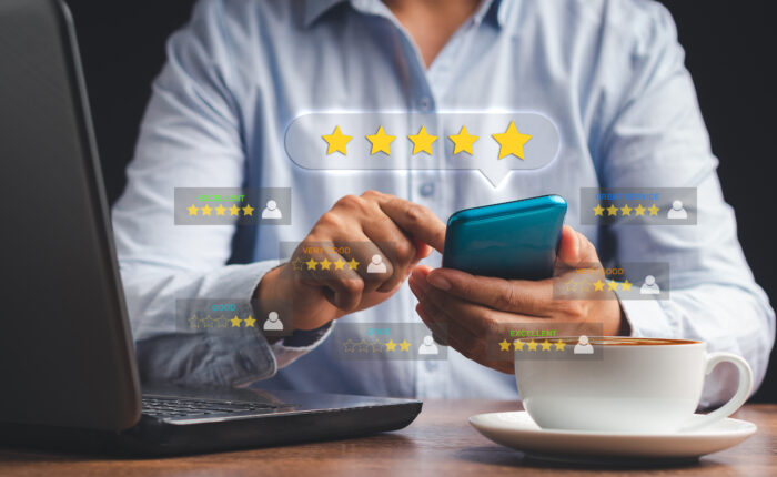 Man using a smartphone give the five-star icon a rating of very