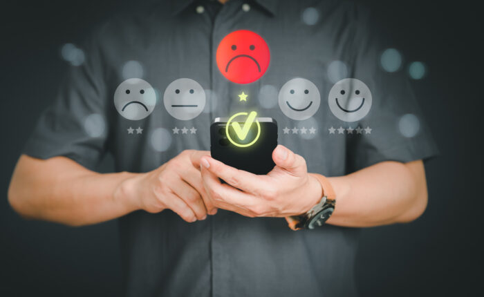 Unhappy man customer with sad emotion face on a mobile phone. Ba